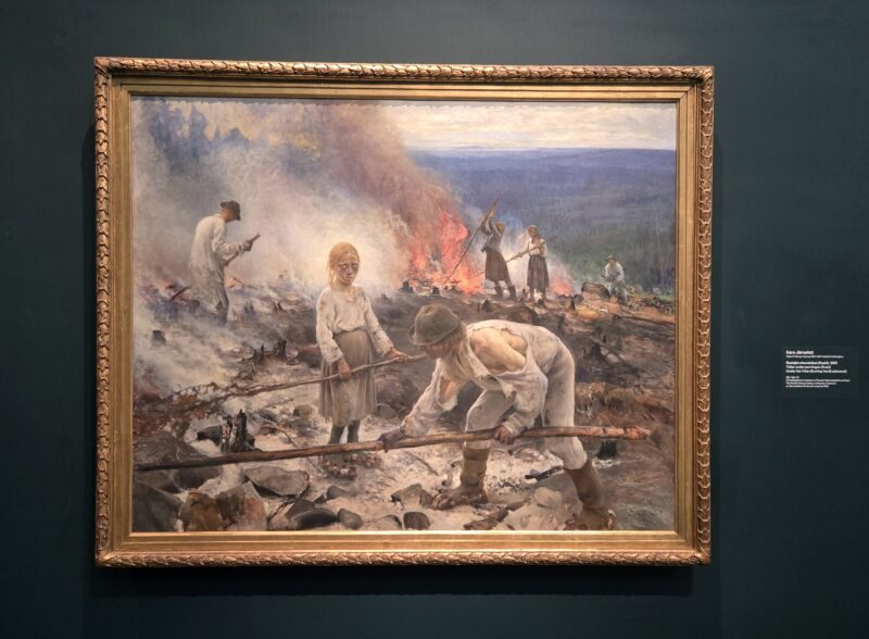 Painting of a smoky battlefield with exhausted figures; a blonde girl in the foreground gazes at the viewer while others dig and tend a fire in the background, debris scattered on the ground.